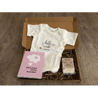 Brievenbuspakketje met rompertje, zeep voor de baby en roze kaart.